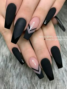 black stiled nails with white and pink accents on them, one nail has an arrow in the middle