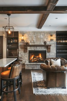 a living room filled with furniture and a fire place in the middle of a kitchen