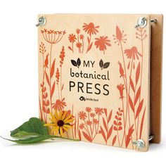 a wooden box with an orange flower on it and the words, my botanical press