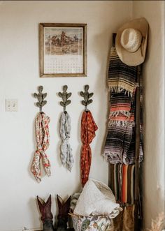 some hats and scarves are hanging on the wall