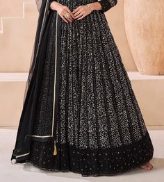 COLOR : Black FABRIC : Top - Pure Georgette, Dupatta - Net WORK : Silk Thread Embroidery, Digital Print, Sequins, Lace Border OCCASION : Party Wear, Festival READY-TO-WEAR : No STITCHING : Available as semi-stitched fabric, can be stitched using standard size option (+$30). Note: There might be a slight color variation due to lighting and flash used during photoshoot. The bright shade seen is the best closer view of fabric's color. Evening Georgette Choli With Floral Embroidery, Evening Choli With Floral Embroidery, Black Choli With Intricate Embroidery In Georgette, Black Embellished Sets For Reception, Black Georgette Lehenga With Floral Embroidery, Evening Embroidered Georgette Lehenga, Festive Embroidered Anarkali Set For Evening, Floor-length Fitted Choli With Floral Embroidery, Black Embellished Long Sleeve Gown