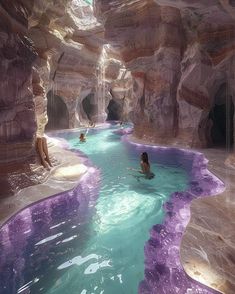 some people are swimming in a pool with purple paint on the walls and water running through it