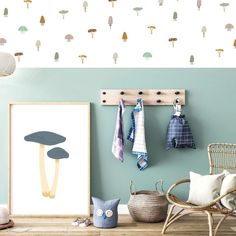 a room with blue walls and mushrooms on the wall, hanging from hooks in front of it