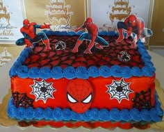 a spiderman birthday cake is displayed on a table