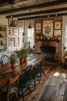 a dining room table with chairs and potted plants on the wall next to it