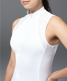 a woman wearing a white top with an open neck and sleeveless design on it