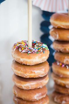 several donuts stacked on top of each other with a candle sticking out of them