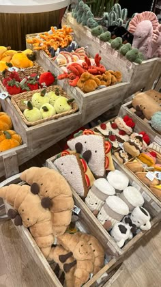 several wooden boxes filled with different types of stuffed animals