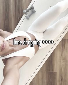 a woman laying on top of a wooden floor next to a white wall with the words lore dropping