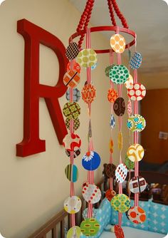 a baby crib with a red letter hanging from it's side