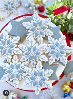 snowflake cookies on a plate with christmas decorations