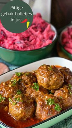 meatballs in gravy with red potatoes and carrots next to the bowl