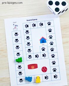 a printable board game with dogs and cats on it, next to dices