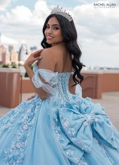 a woman in a blue dress with a tiara