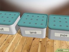 three plastic containers with words on them sitting on a wooden floor next to each other