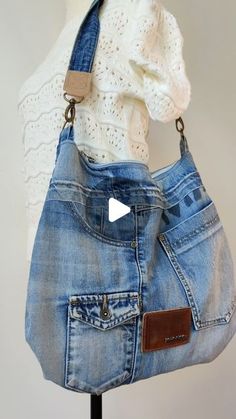 a handbag made out of jeans and an old pair of pants is hanging on a mannequin's head