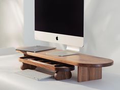 an apple computer sitting on top of a wooden desk