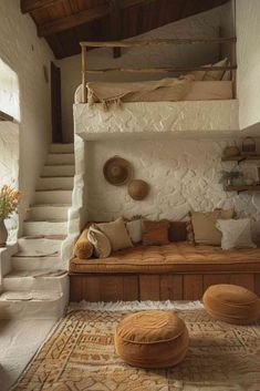 a living room filled with lots of furniture next to a stair case on top of a rug