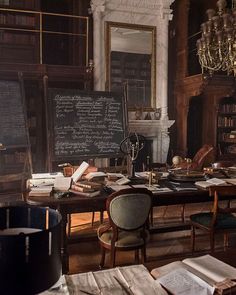 an old library with lots of books and writing on the chalkboard in front of it