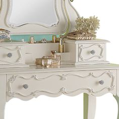 a white dresser with a mirror and drawers