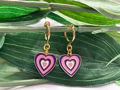 Pretty little earrings! For those that want to wear hoops but do not have pierced ears! Perfect These are made with a gold tone spring clip on hoops (13mm) with gold tone purple/pink hearts (12mm) attached  This is a set of 2 hoops More Gold hoop Clips https://www.etsy.com/uk/listing/704679868/pearl-hoop-dangle-clip-on-earrings-girls?ref=shop_home_active_68&sca=1 ESTIMATED DELIVERY TIMES SHIPPING FROM UK: UK: Royal Mail First Class:  1-3 business day Canada: Royal Mail Standard International Shipping:  7-30 business days North America: Royal Mail Standard International Shipping:  7-21 business days Europe: Royal Mail Standard Shipping:   3-10 business days Australia, New Zealand and Oceania: Royal Mail Standard International Shipping:  7-31 business days May vary during busy periods Once y Pink Hoop Earrings For Valentine's Day, Cute Pink Hoop Earrings For Valentine's Day, Pink Heart Huggie Earrings For Pierced Ears, Pink Huggie Heart Earrings For Pierced Ears, Cute Pink Huggie Jewelry, Cute Hypoallergenic Hoop Earrings, Cute Single Hoop Earring, Playful Pink Hoop Earrings Gift, Playful Hoop Jewelry Gift