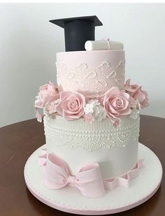 a three tiered cake with pink and white flowers