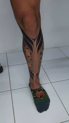 a man with tattoos on his legs and feet