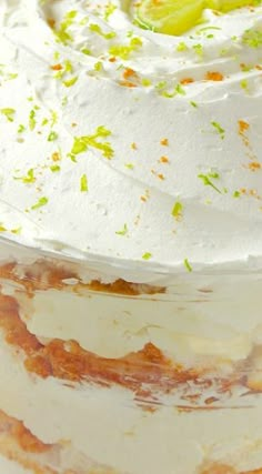 a cake with white frosting and green sprinkles