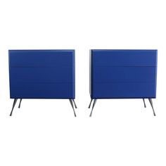 two blue dressers sitting side by side on top of each other with metal legs