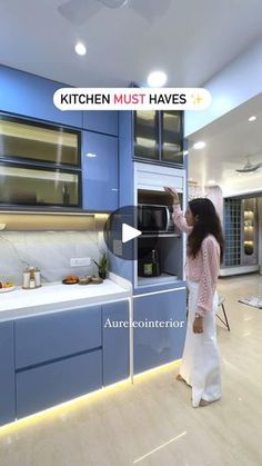 a woman standing in front of a kitchen stove top oven next to a white counter