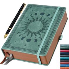 a book with a pen on top of it next to colored pencils and an image of the sun