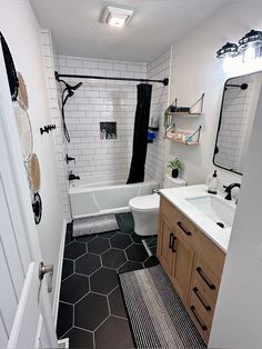 a bathroom with black and white tile flooring