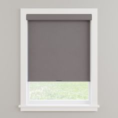 a grey roller shade in a window