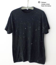 NEW Hand painted white and gray paint splatters on a black tee shirt, inspired by shooting stars. The manufacture of the original Tee shirt is JERZEES, 50% cotton/50% Polyester.  SIZE LARGE Unisex(Men's):   Approx. dimensions according to Jerzees are as follows: Width across the chest  is approx. 22inches, and  Length  is approx. 30 inches. More T-Shirts: https://www.etsy.com/shop/Styleon I try is get the colors as close to actual. Please note every computer monitor is different. Washing Instructions:  This tee has been washed since it was painted and is ready to wear!  Next time, turn inside out and wash in cold water, gentle cycle, then tumble dry low.  Do not iron. Relaxed Fit Cotton Top With Paint Splatter, Casual Black Top With Paint Splatter, Black Cotton Tops With Paint Splatter, Black Bleached Relaxed Fit Tops, Black Short Sleeve Tops With Paint Splatter, Black Bleached Graphic Tee, Black Cotton Top With Paint Splatter, Grunge Style Star Print T-shirt For Summer, Black Cotton Tops With Paint Splatter Detail