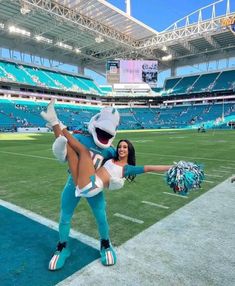 a cheerleader is dancing on the field at a football game