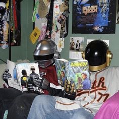 a person sitting on a couch wearing a helmet and reading a book