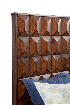 a bed with wooden headboard and blue pillow on it's side, against a white background