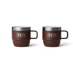 two brown yeti mugs sitting next to each other on a white background with the words yeti in silver lettering