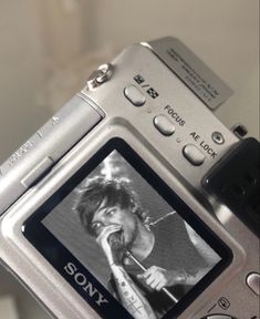 a digital camera with an image of a person holding a microphone