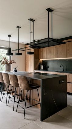 Black Marble Waterfall Island, Modern Sleek Kitchen Island, Black And Wood Kitchen Island, Textured Kitchen Island, White Kitchen Black Cabinets, Black Waterfall Island Kitchen, Black Waterfall Island, Black Island Countertop, Black Marble Kitchen Island