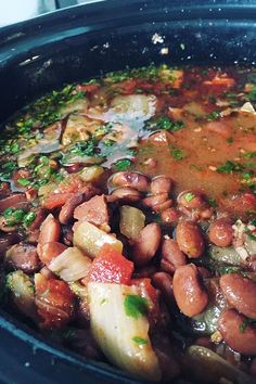 beans and onions are cooked in the slow cooker