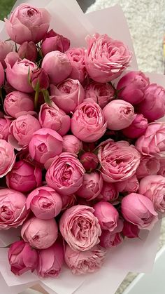 a bouquet of pink roses sitting on top of a table