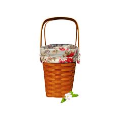 a brown basket with flowers on it and a white flower in the bottom right corner