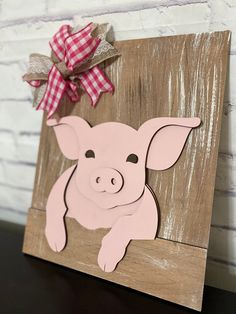 a wooden sign with a pig cut out on it