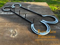 a pair of scissors sitting on top of a piece of wood