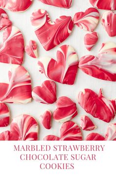 some red and white heart shaped cookies on a table