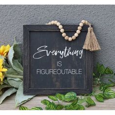 a sign that says everything is fagurequatable next to some flowers