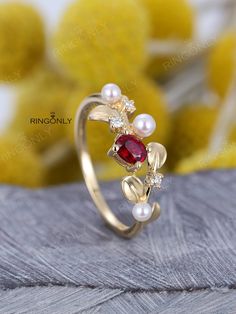 Pearl engagement ring 14k gold Unique engagement ring Oval Shaped Lab Ruby Dainty Leaf Cluster alternative diamond Anniversary gift for women PRODUCT SPECIFICATIONS Handmade item -Metal Type:Yellow Gold,White Gold,Rose Gold,(14K or 18K) - Lab Ruby Size: 4*5mm - Akoya Pearl Size: 4mm*1, 3mm*2 -Natural &conflict free diamond Carat: 0.06ct Shape: Round Color: H Cut: VG -Ring Front Size:8mm -1.1mm(thickness) 1.3mm(width) -Total Weight:2.5g ------------------------------------------ We offer the Pearl And Ruby Ring, Ruby And Pearl Ring, Gold Unique Engagement Ring, Ruby Wedding Rings, Engagement Ring Oval, Red Stone Ring, Pearl Engagement Ring, Diamond Alternatives, Gold Ring Designs