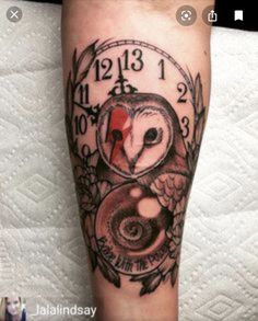 an owl clock tattoo on the leg