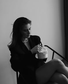 a woman sitting in a chair eating cake